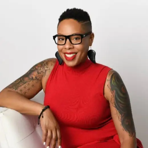 Dr. Tip Jones seated in a red dress